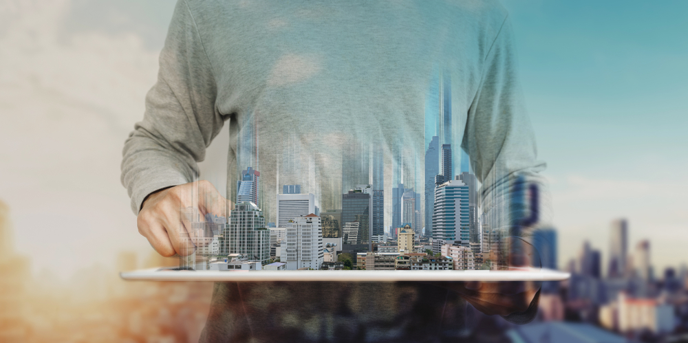 A,Man,Using,Digital,Tablet,,And,Modern,Buildings,Hologram.,Real A,Man,Using,Digital,Tablet,,And,Modern,Buildings,Hologram.,Real